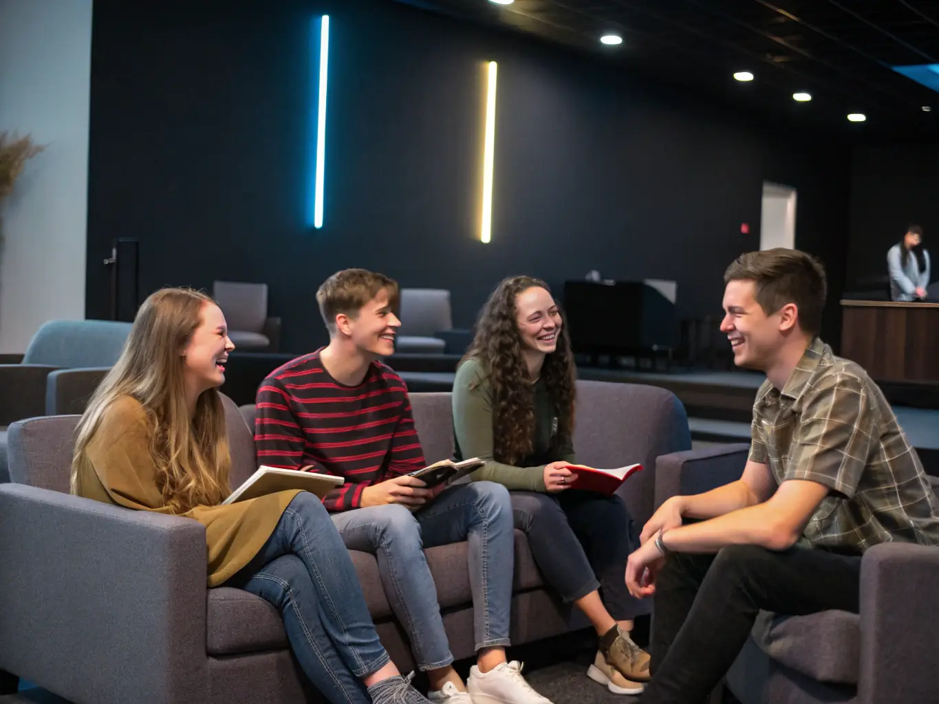 A group of young adults participating in a youth ministry event at Work For Jesus Church, laughing and engaging in a team-building activity.